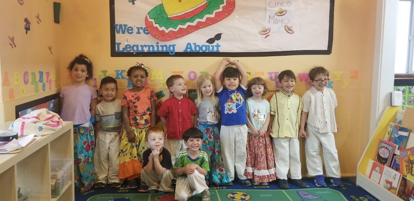 Group of children standing in a classroom