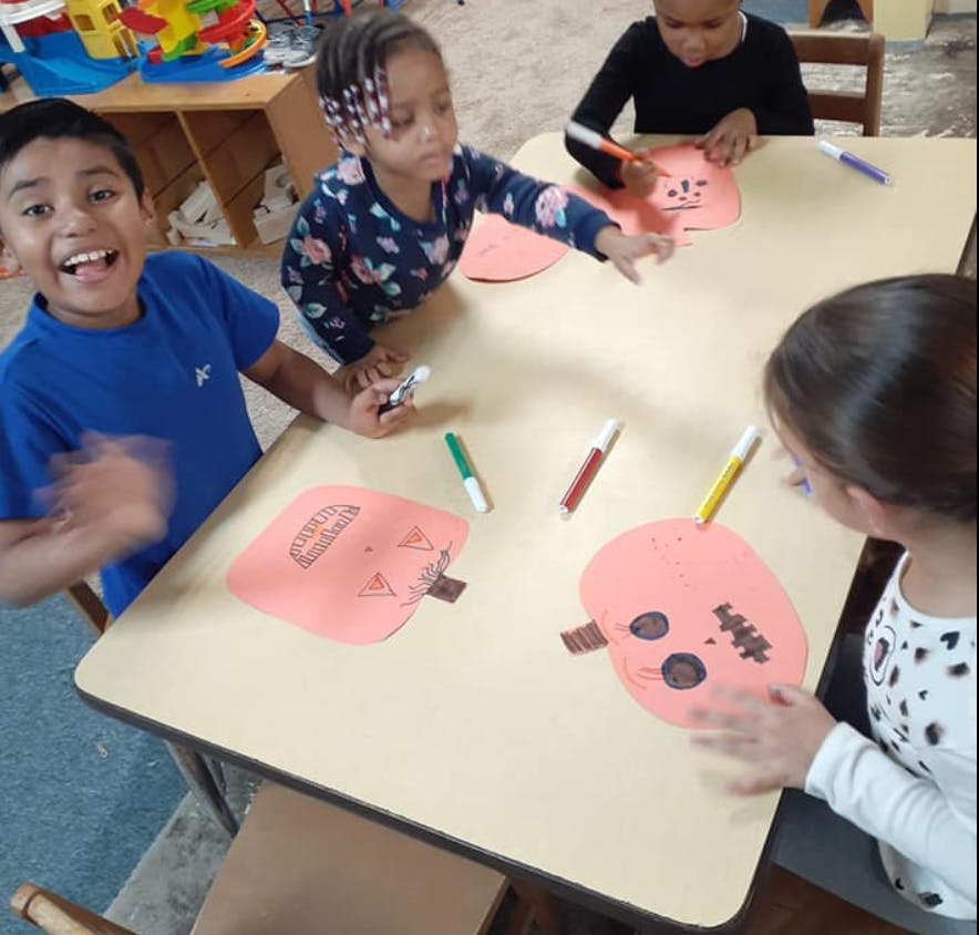 Children making crafts at a table