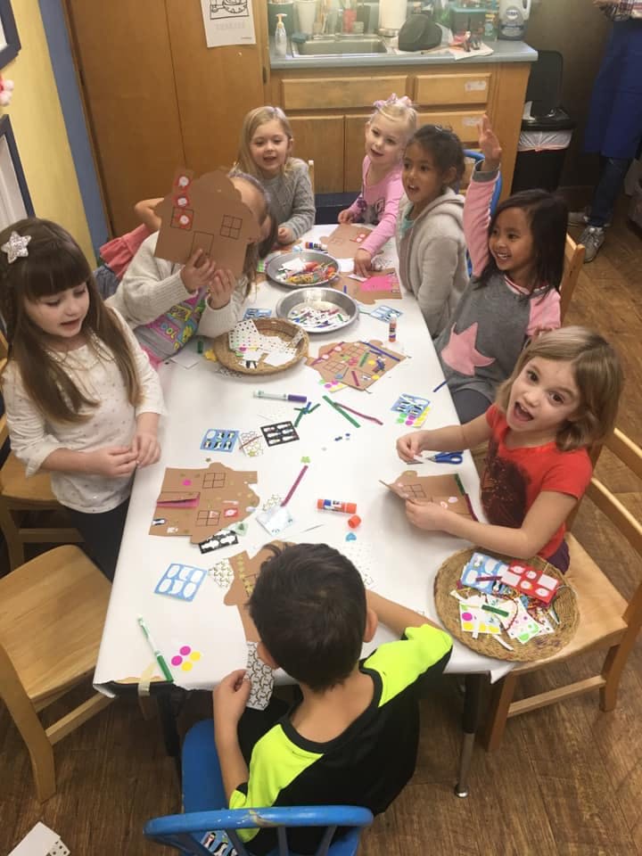 Children sitting around a table doing crafts