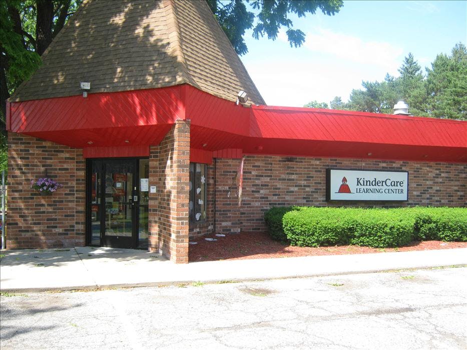 Brick building with a red roof and a KinderCare Learning Center sign