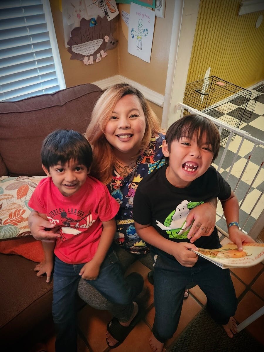 Person smiling with two children