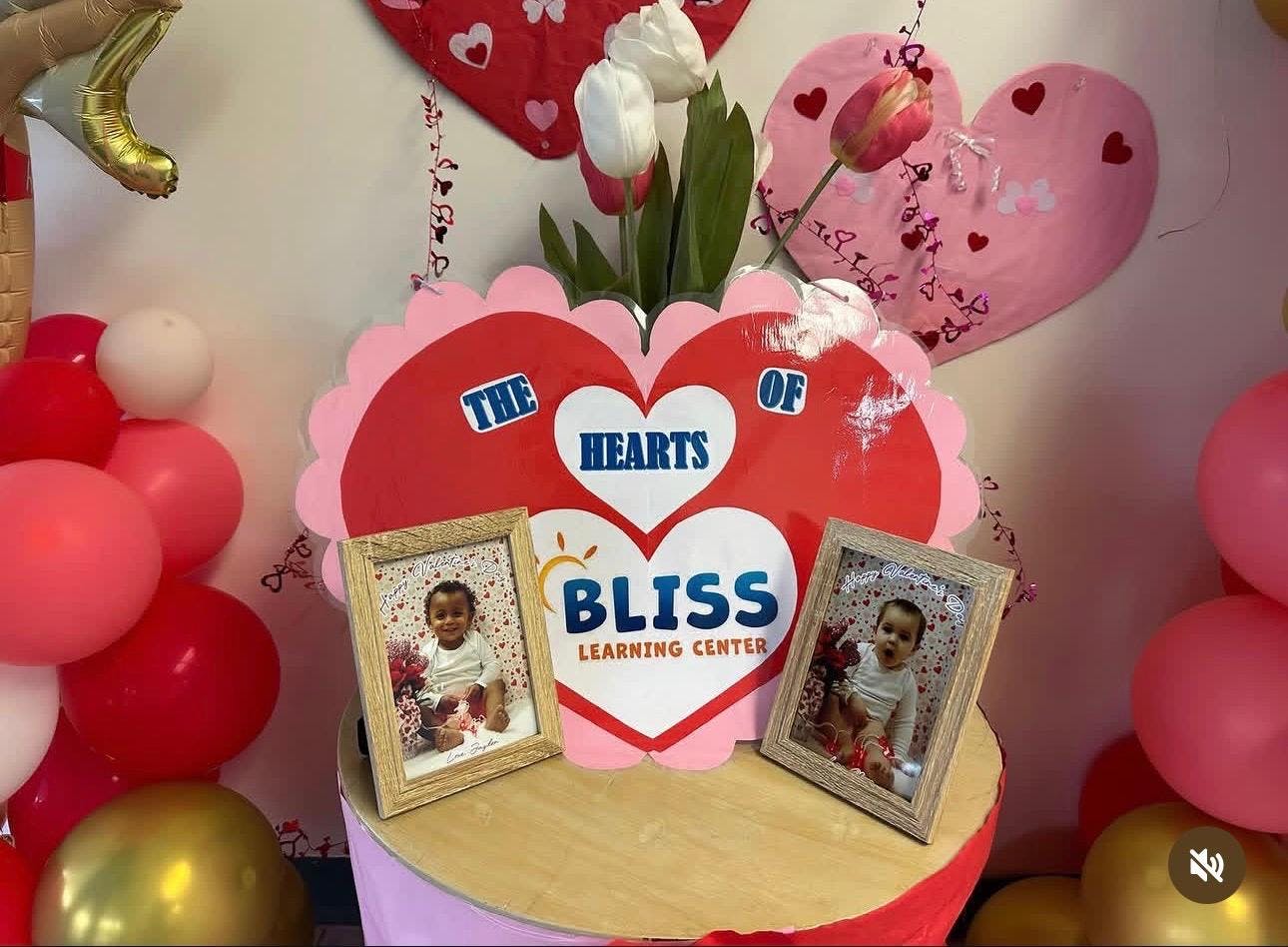 Bliss Learning Center display with heart decorations and framed photos of children