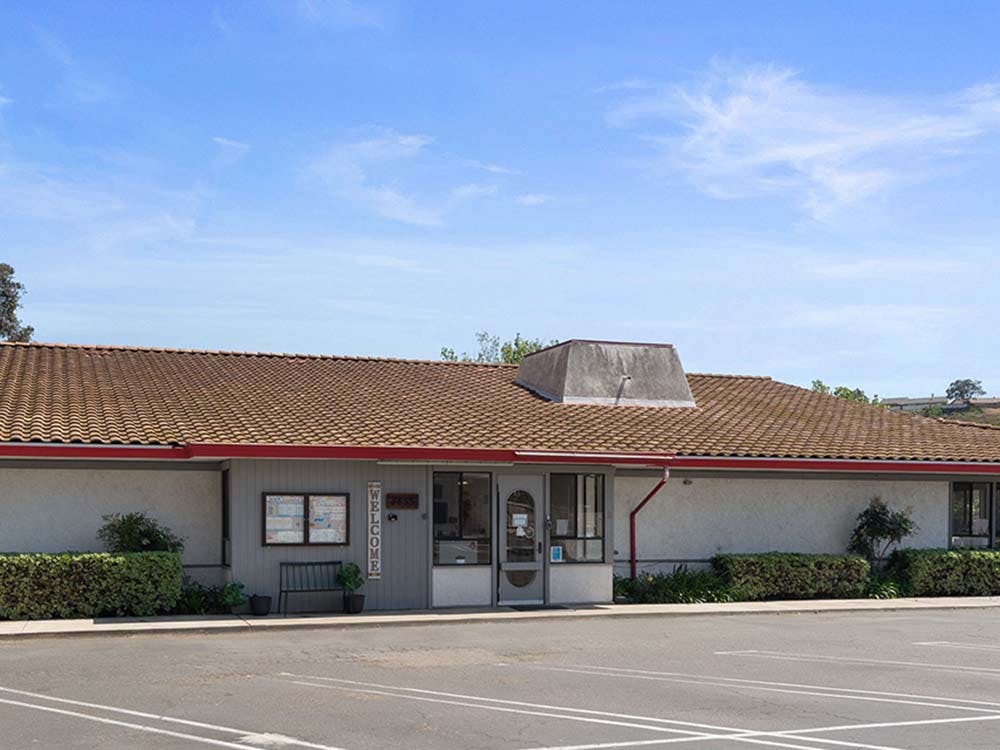 Building with a tiled roof and a Welcome sign on the entrance
