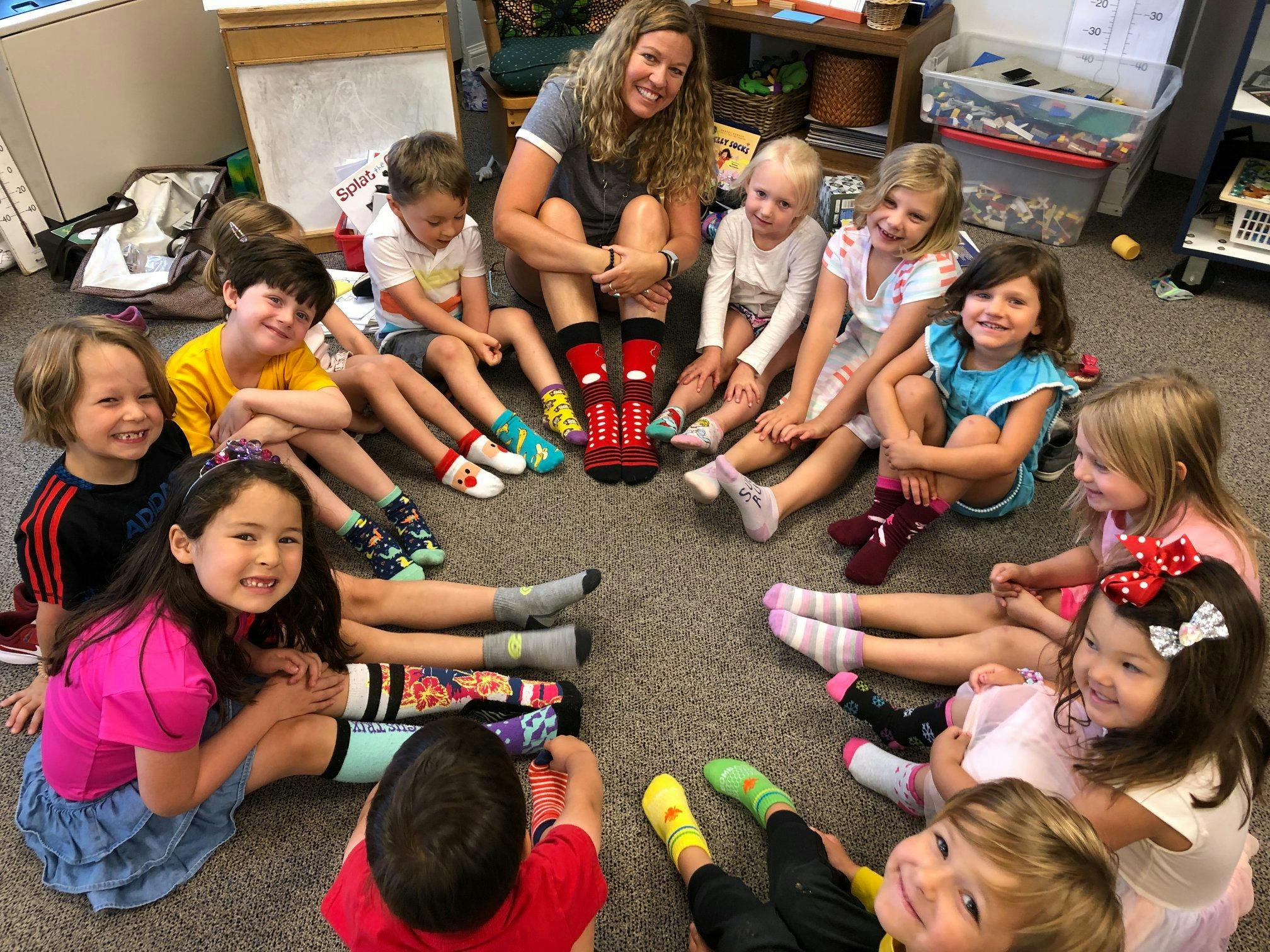 Adult and children sitting in a circle on the floor