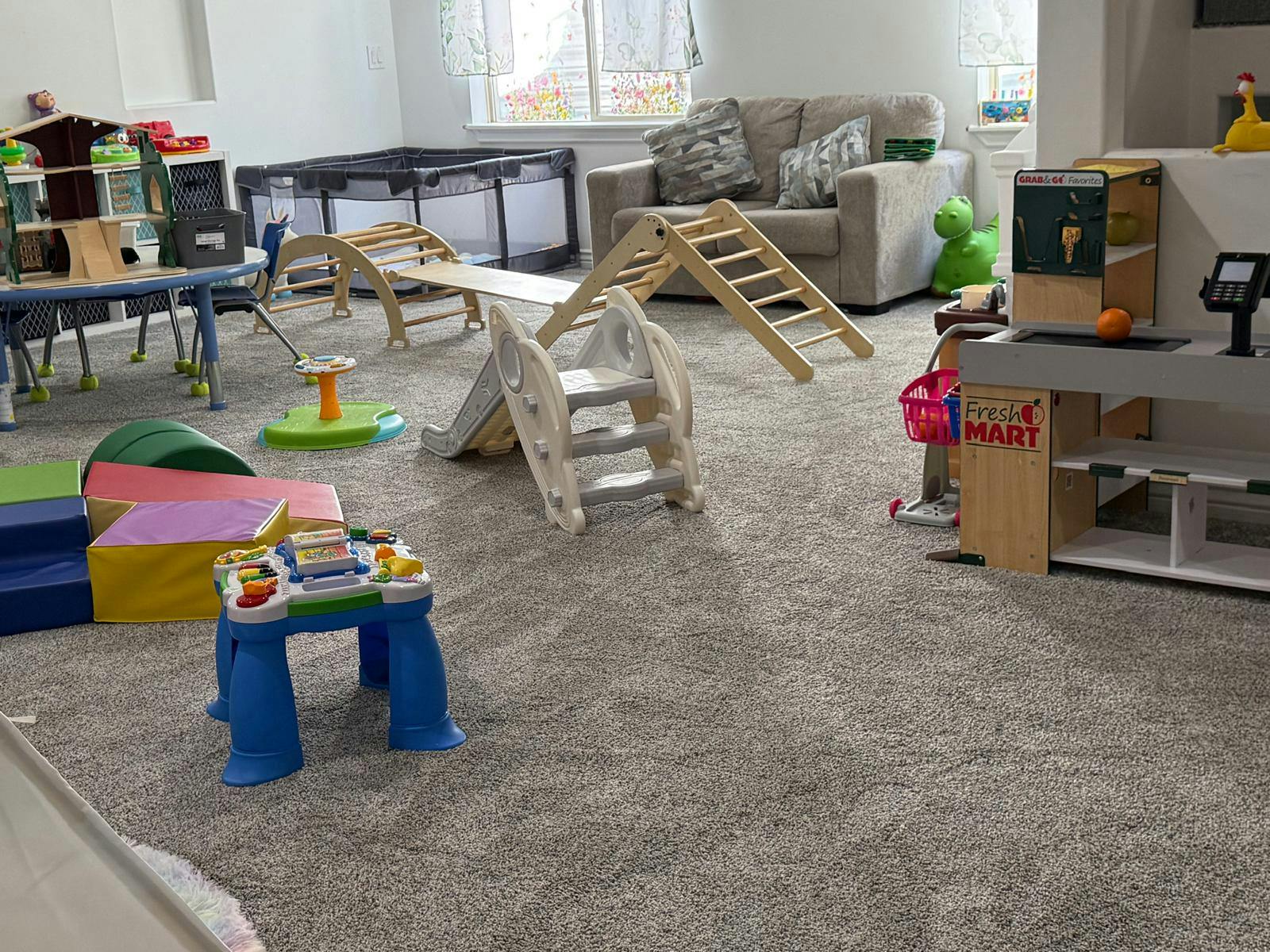 Indoor play area with various climbing structures and toys