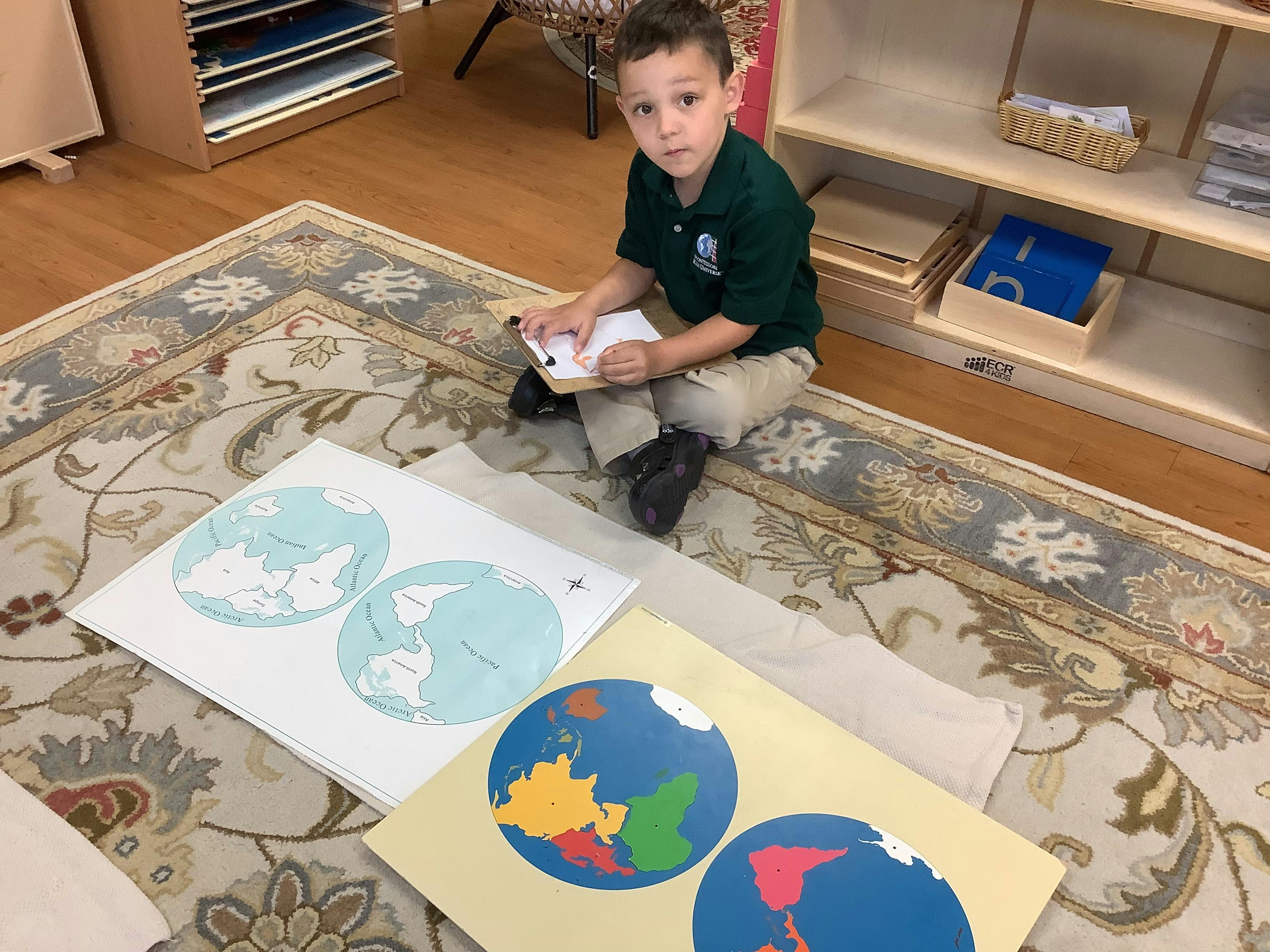 Child sitting on a rug with world map puzzles