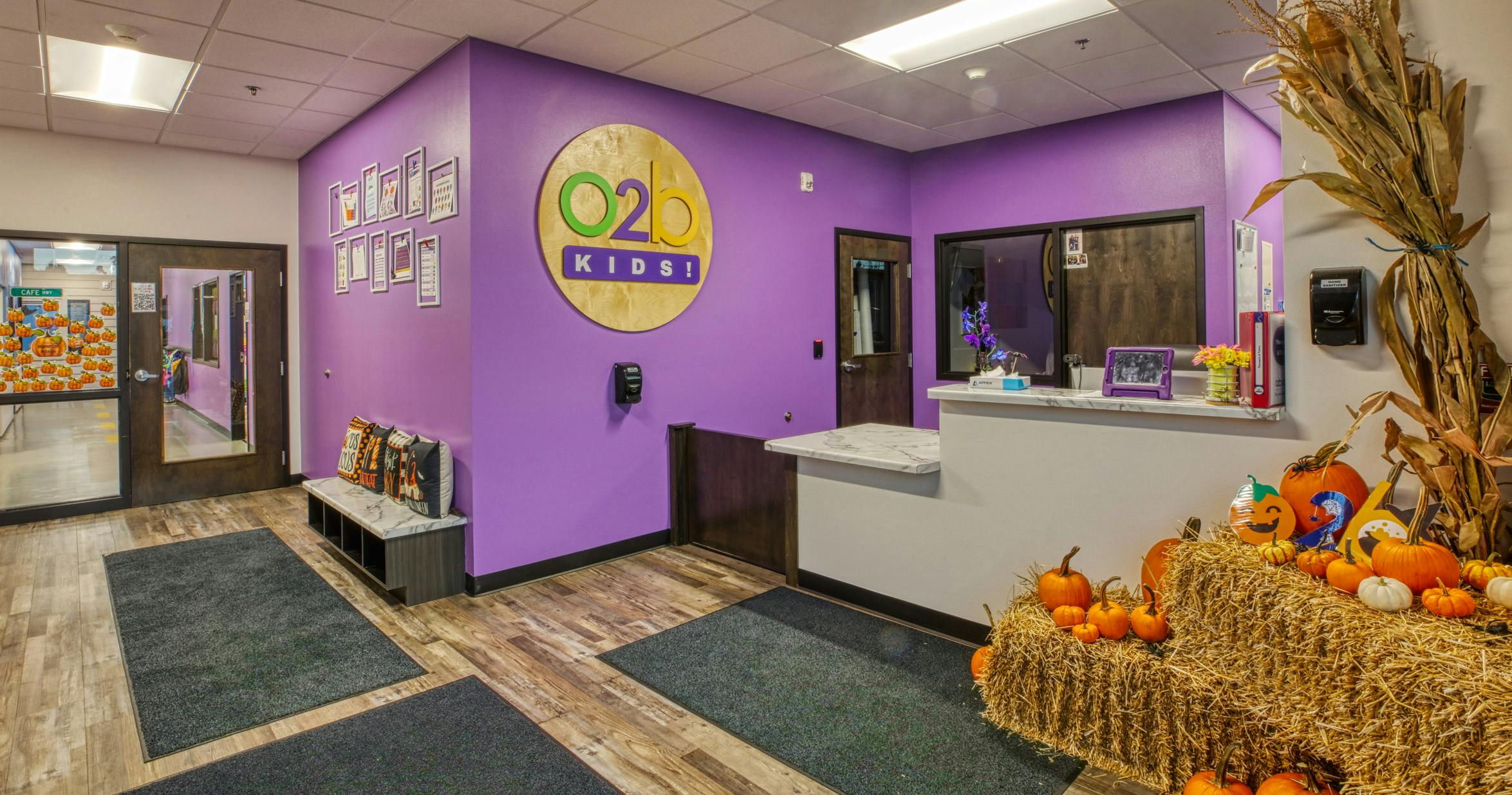 Lobby with purple walls, O2B Kids logo, and Halloween decorations