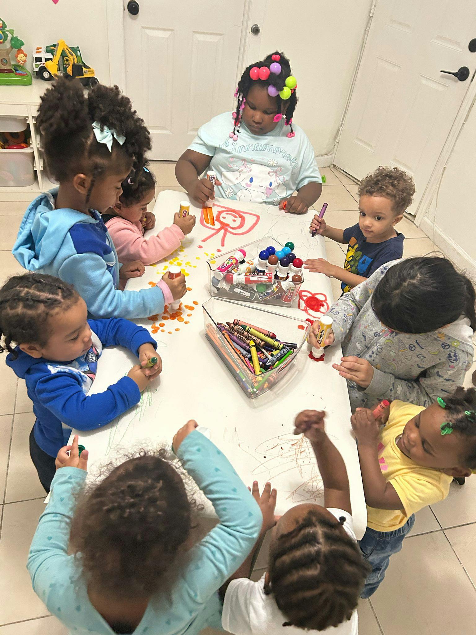 Children drawing and coloring at a table