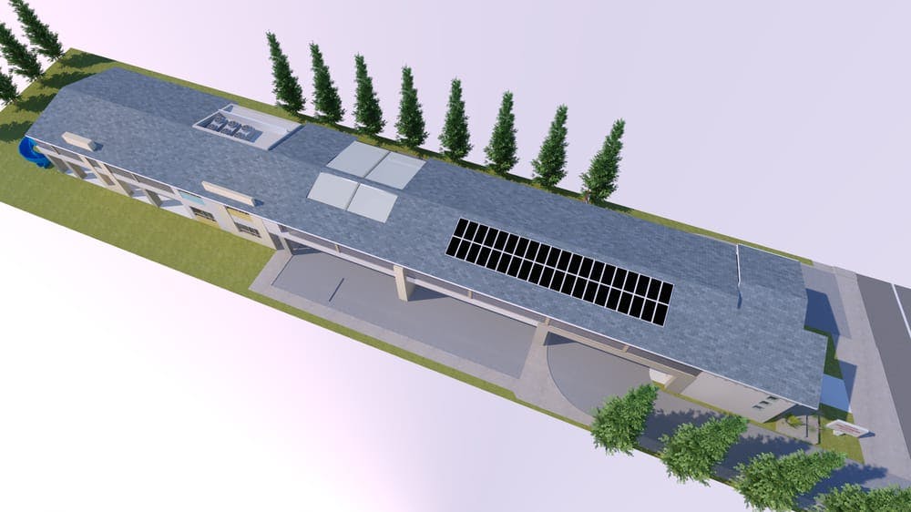 Aerial view of a building with solar panels on the roof