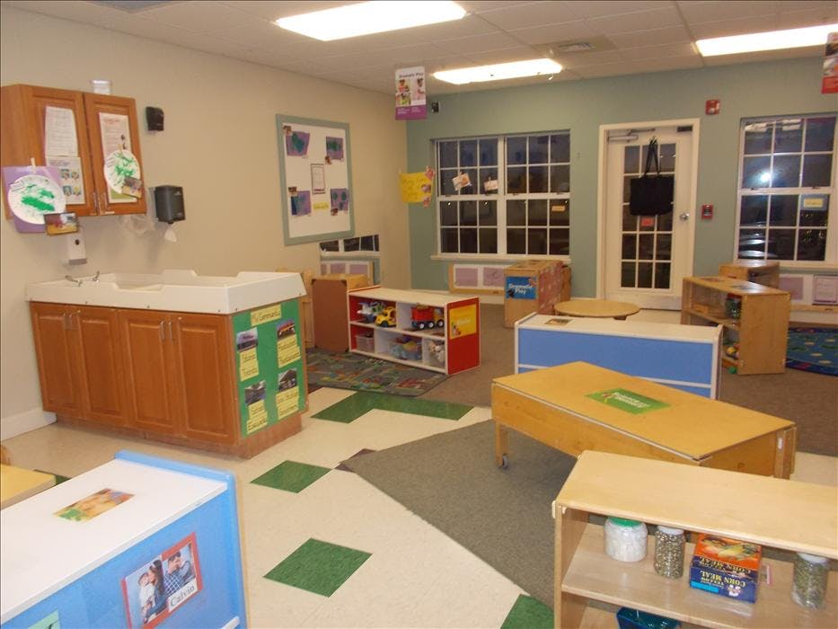 Empty classroom with a changing table and various educational toys and furniture