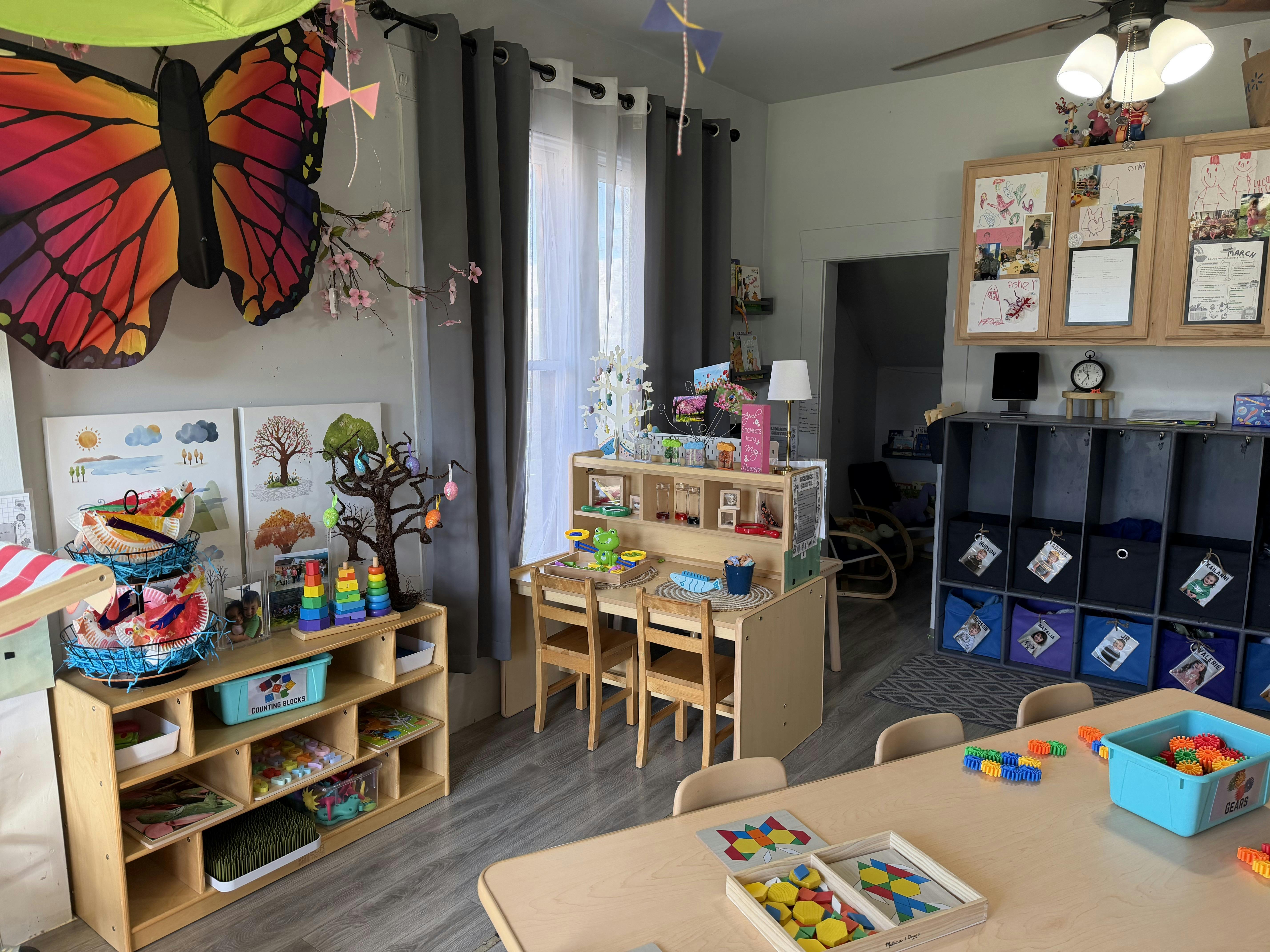 Classroom interior with small wooden tables and educational toys for children
