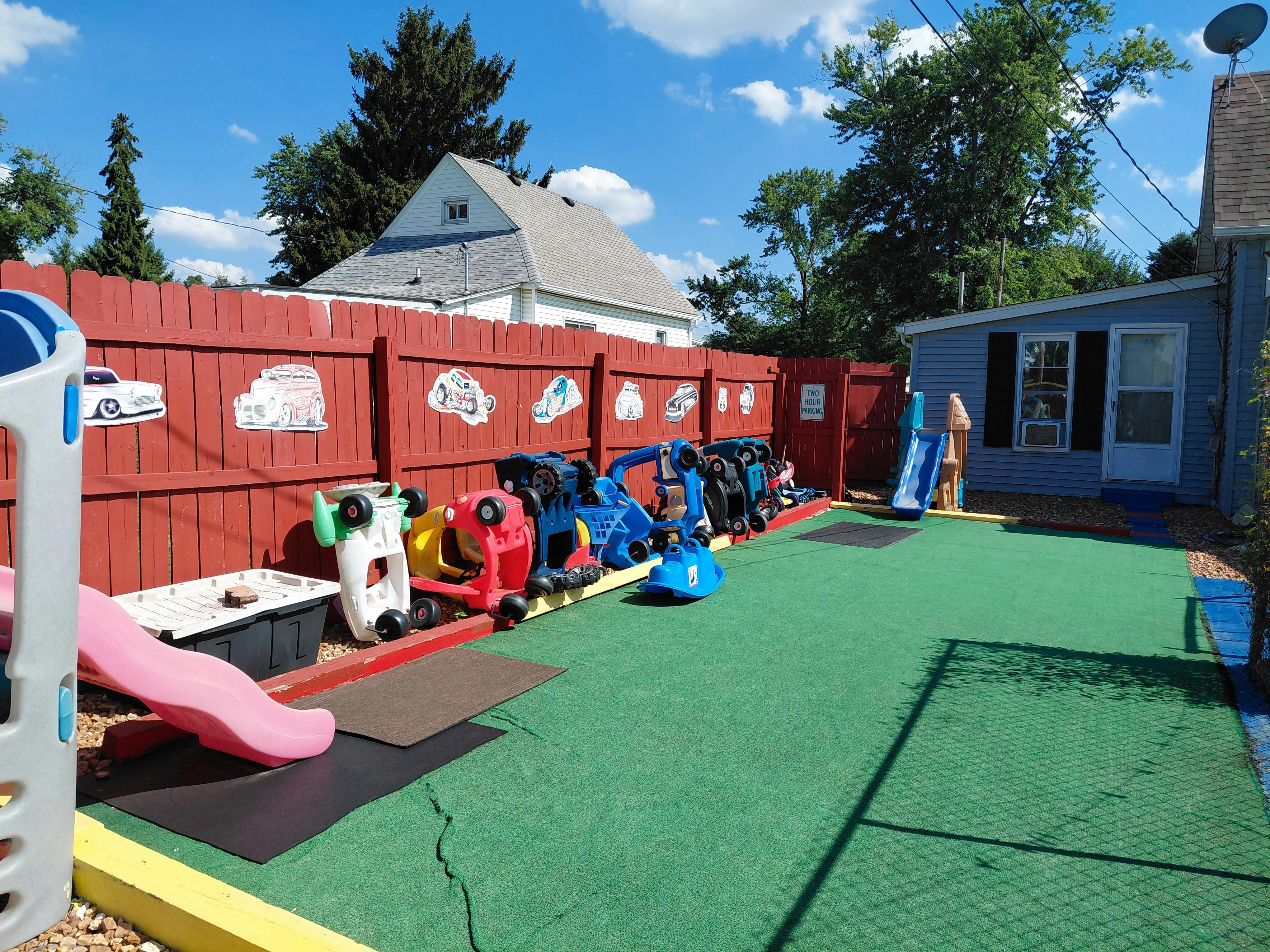 Outdoor playground with ride-on toys and slides