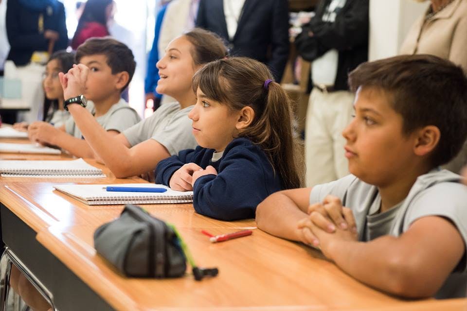 Children sitting at desks in a classroom