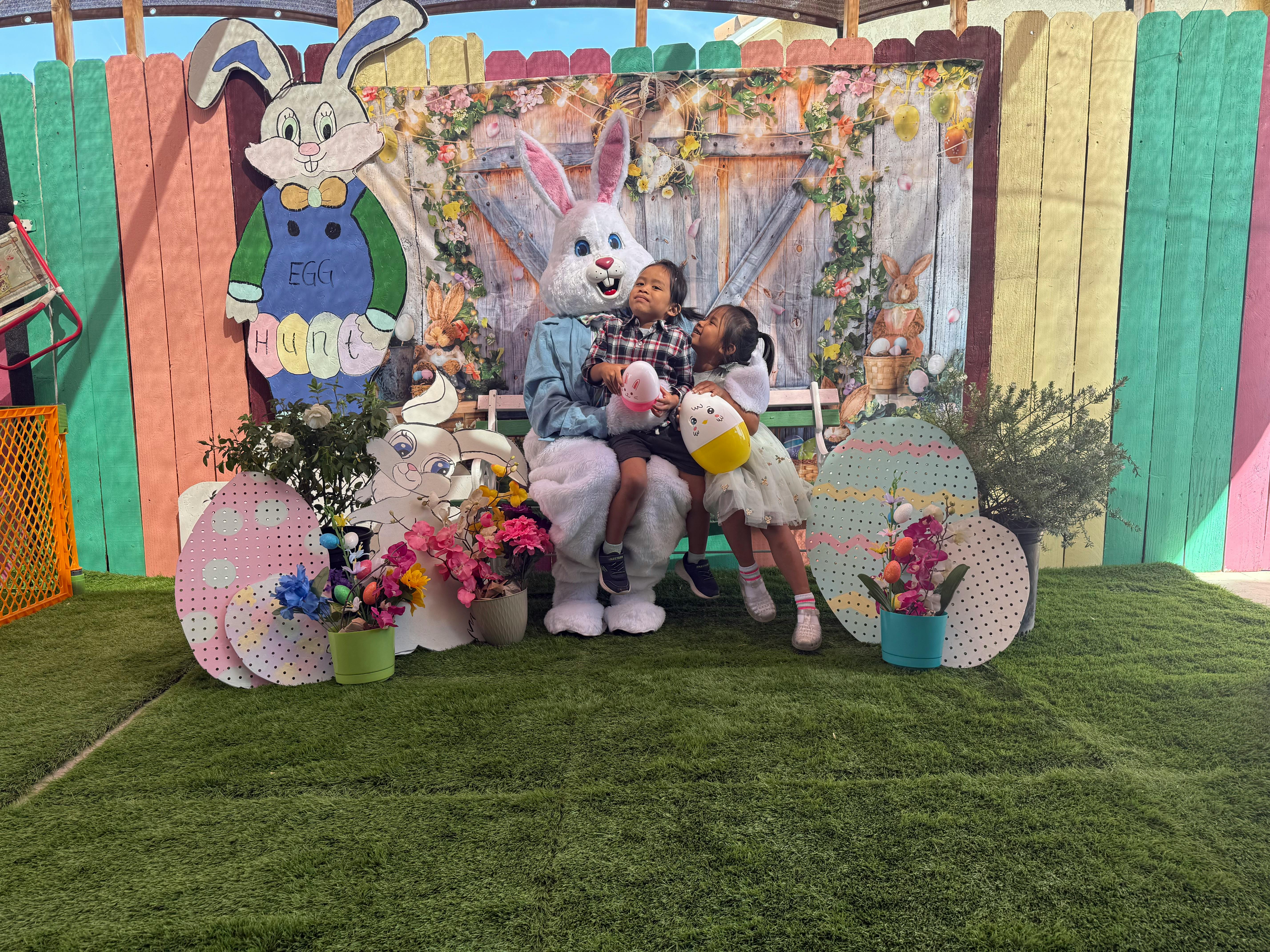 Person in bunny costume with two children