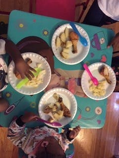 Children eating meals at a table