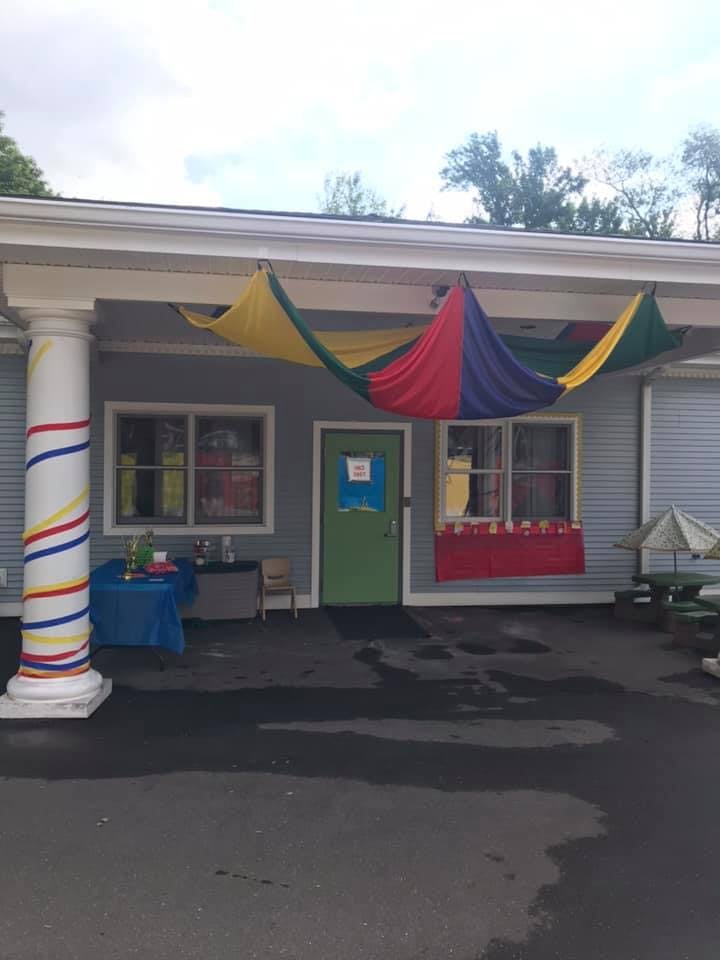 Building exterior with colorful fabric draped over the entrance