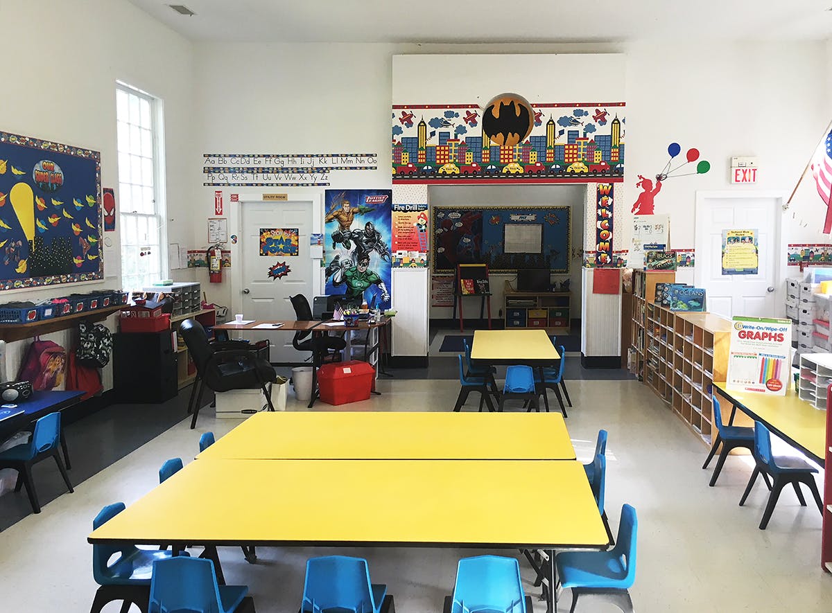 Classroom with yellow tables and blue chairs
