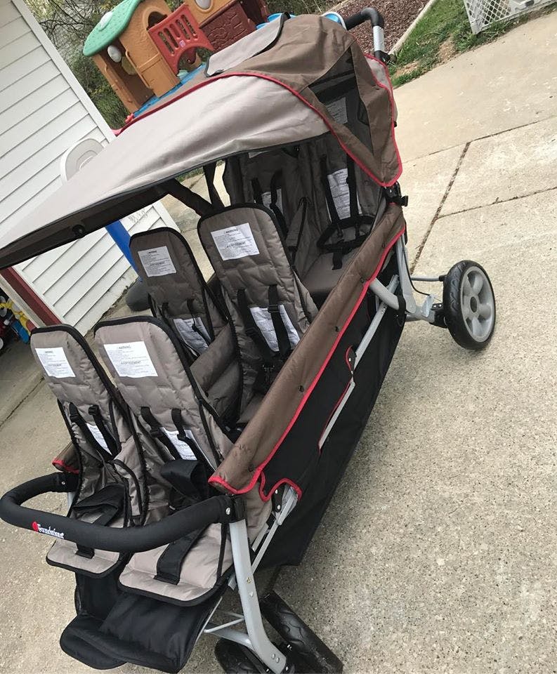 Triple stroller with three seats and a canopy