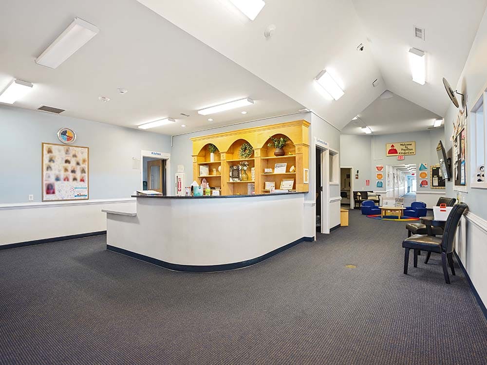 Reception desk in a childcare center with hallways leading off to other rooms