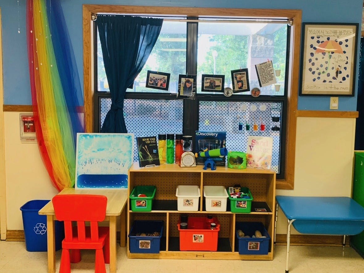 Classroom science and activity area with shelves, tables, and a window