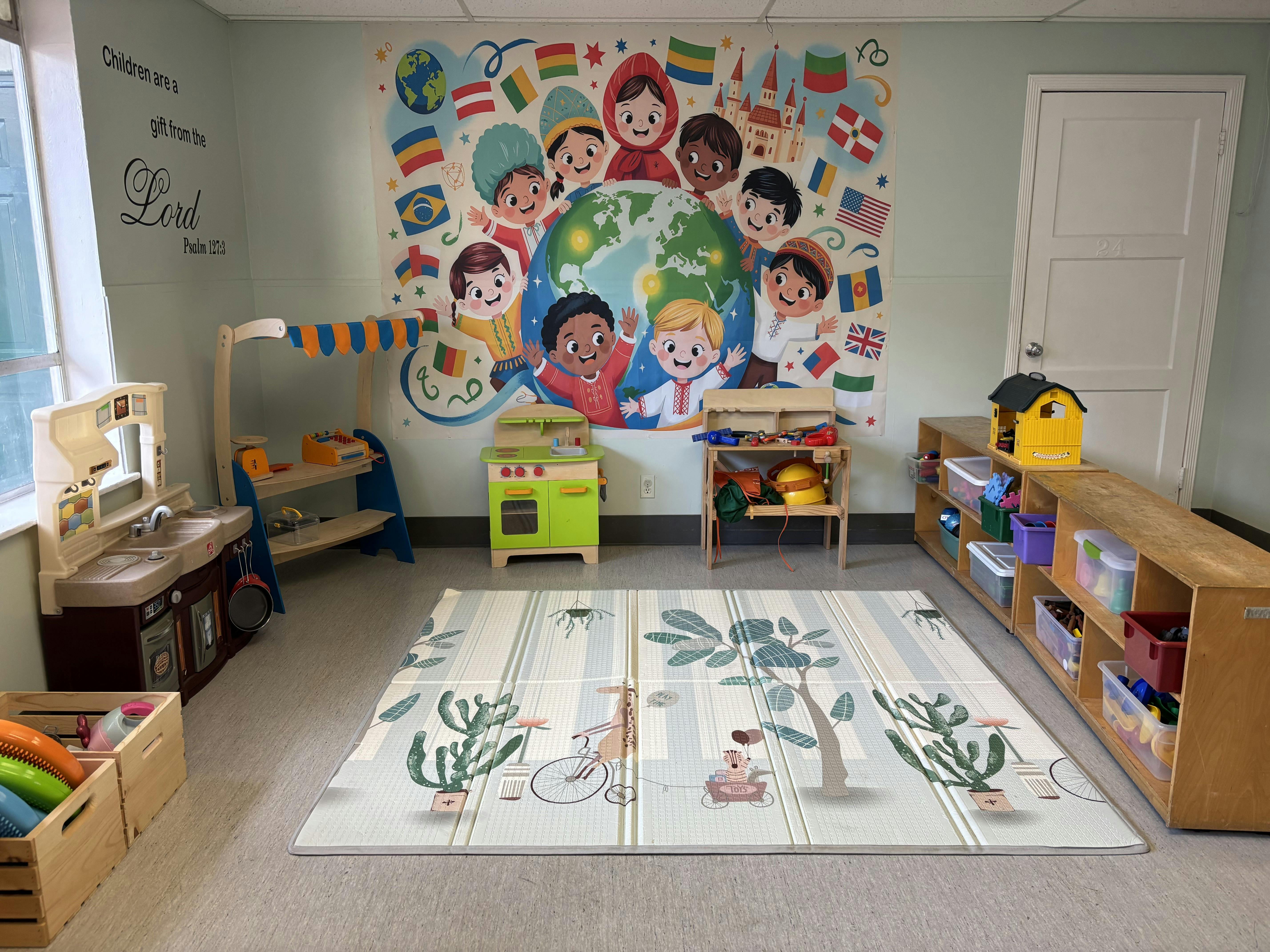 Playroom with a world map mural, play kitchen, and toy shelves
