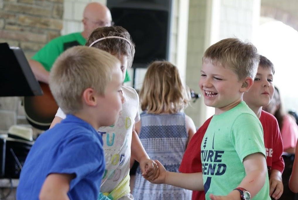 Two children holding hands and smiling