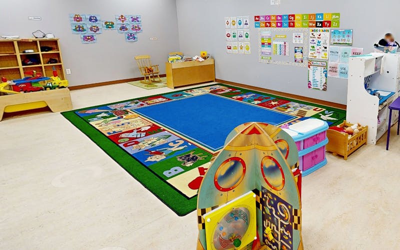 Classroom with colorful rug and various learning materials