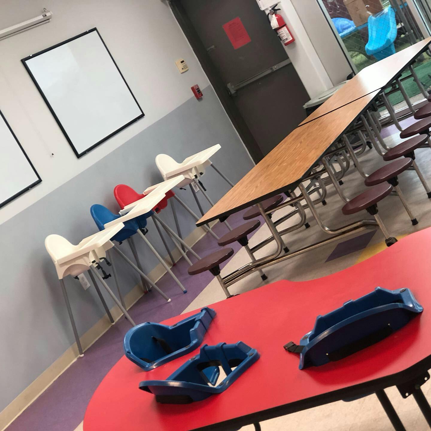 High chairs and cafeteria tables in a room