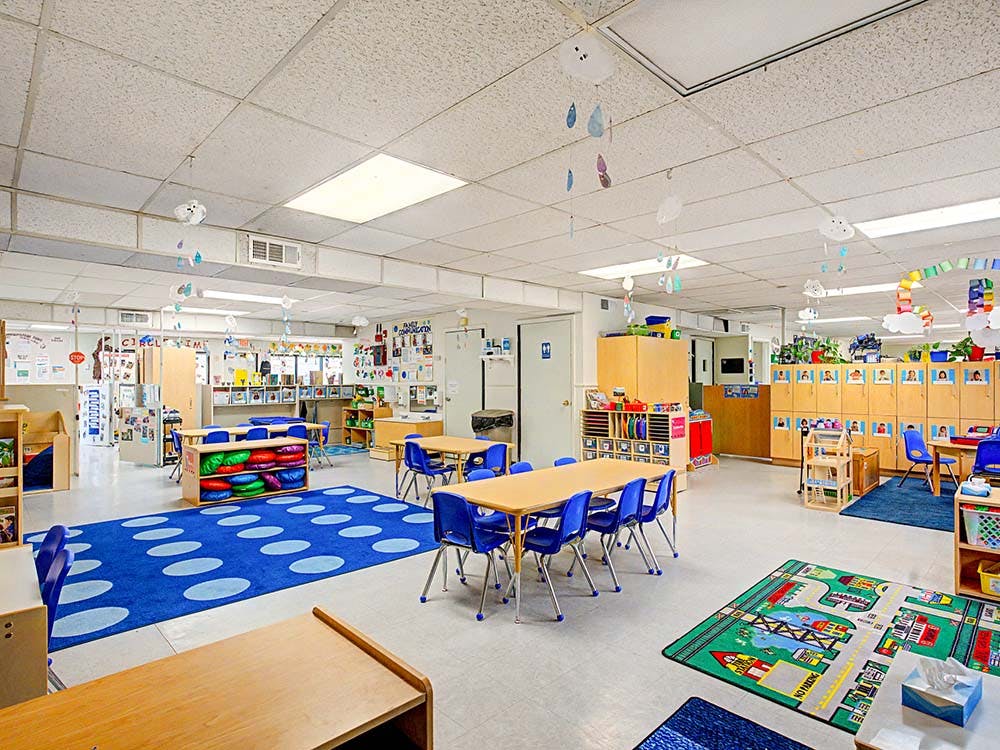 Classroom with tables, chairs, and play areas