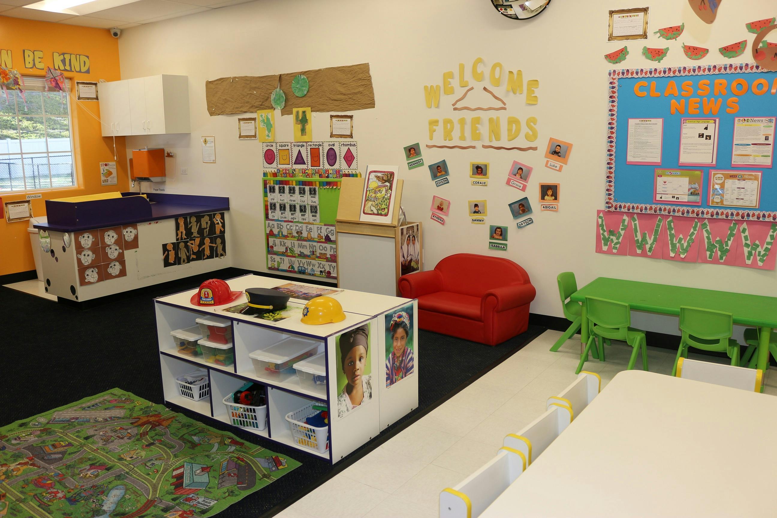 Classroom with small tables, chairs, and play areas