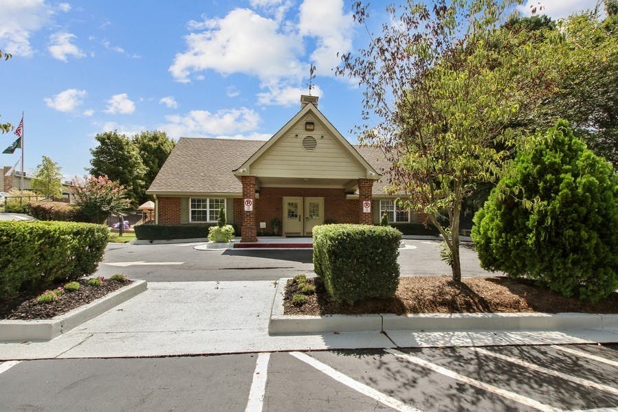Building exterior with a gabled entrance and a paved driveway
