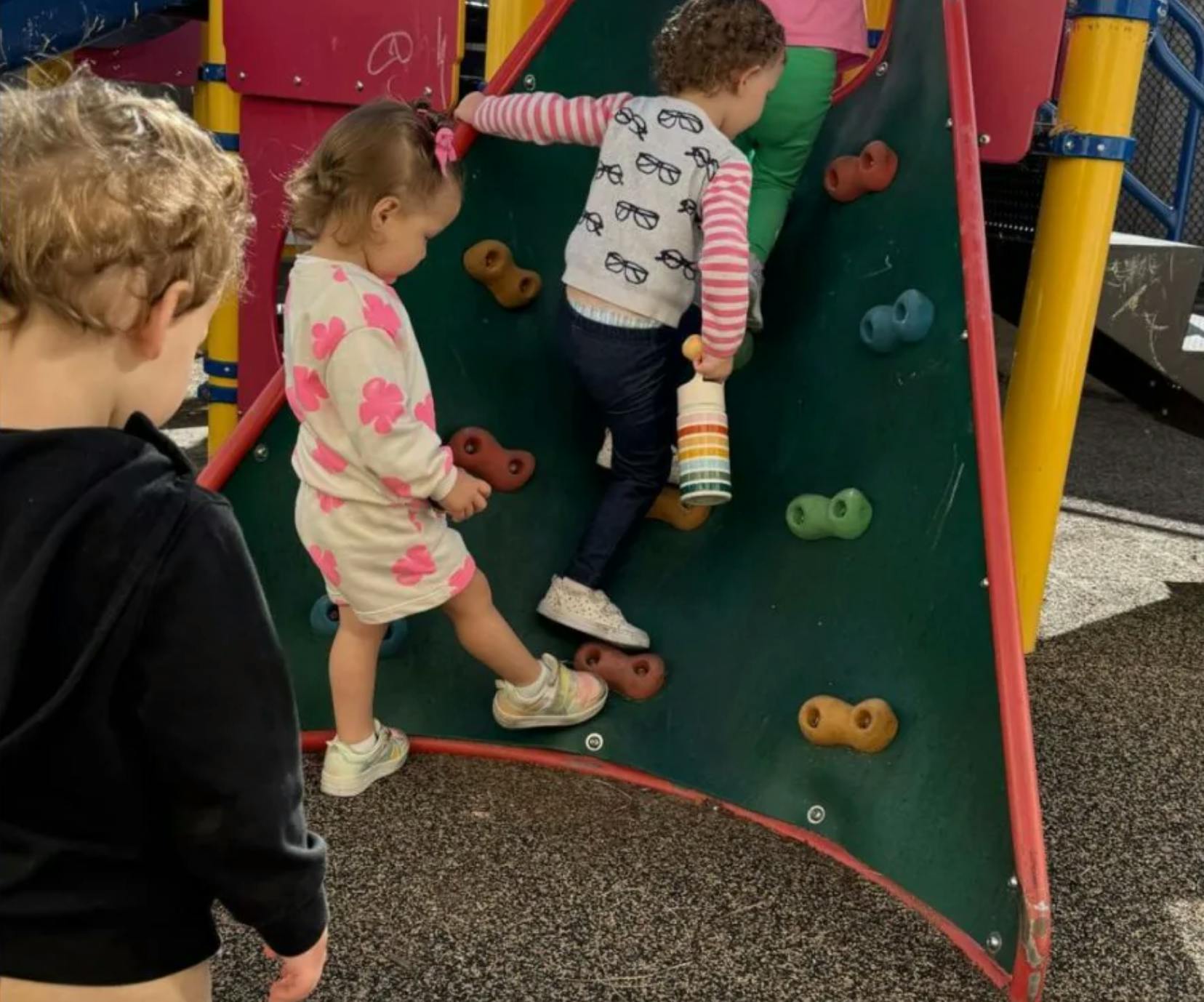 Children climbing a wall on a playground