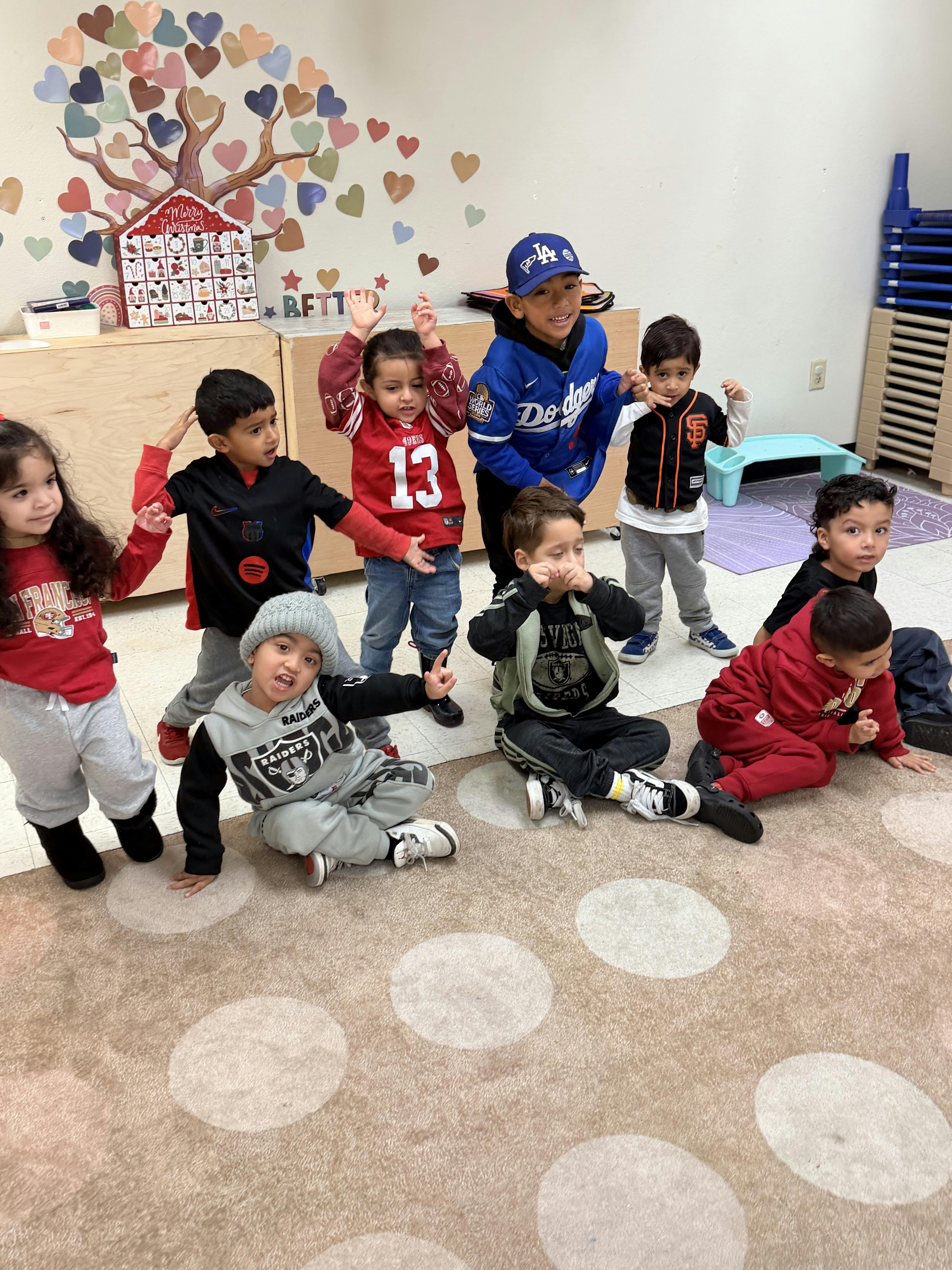 Group of children standing and sitting on a carpeted floor