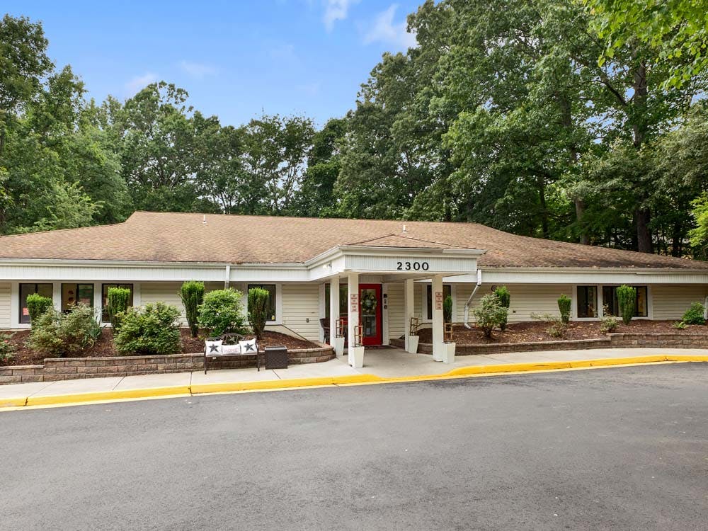 Building with 2300 over the entrance, surrounded by trees and landscaping