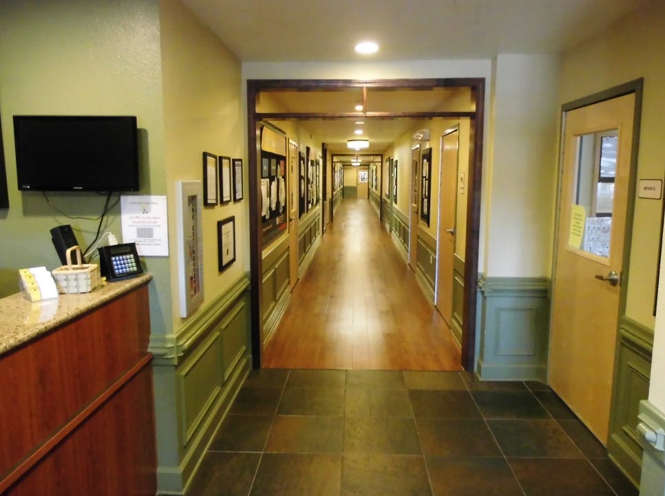 Long hallway with a reception desk on the left