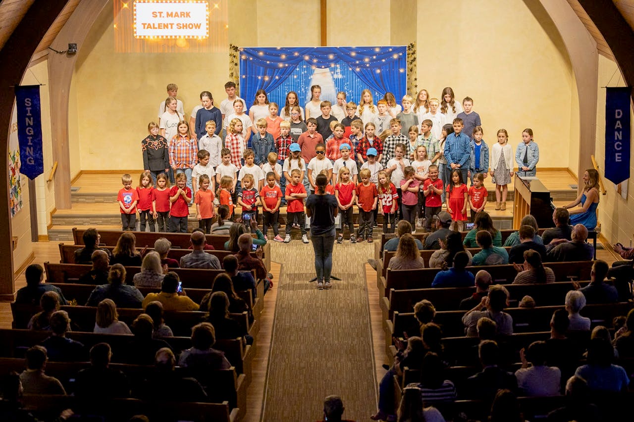 Group of children performing on a stage during a St. Mark talent show