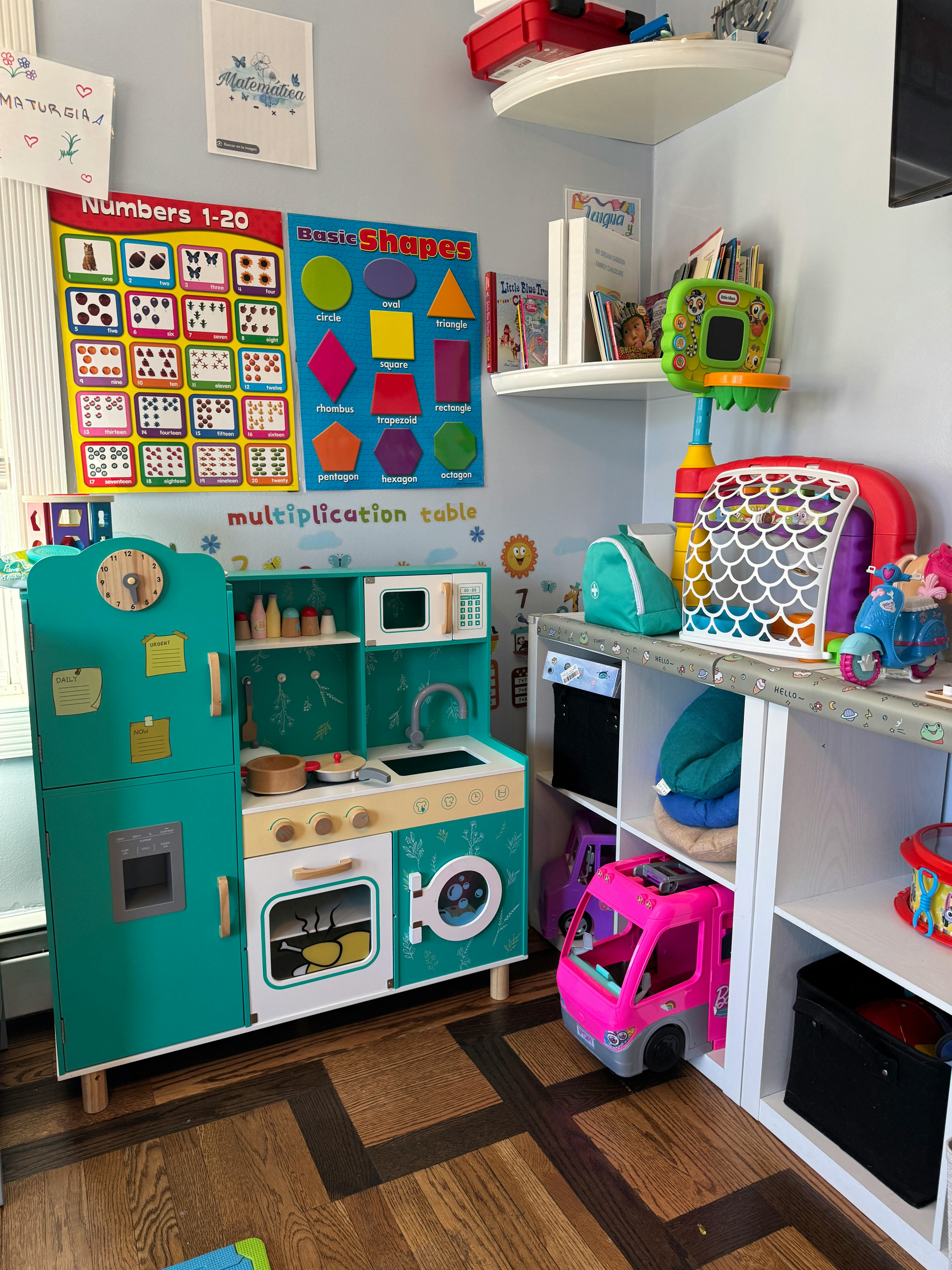 Child's play kitchen with refrigerator, stove, and sink