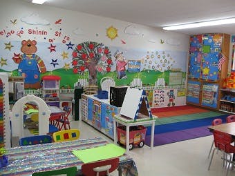 Preschool classroom with colorful wall murals and play areas