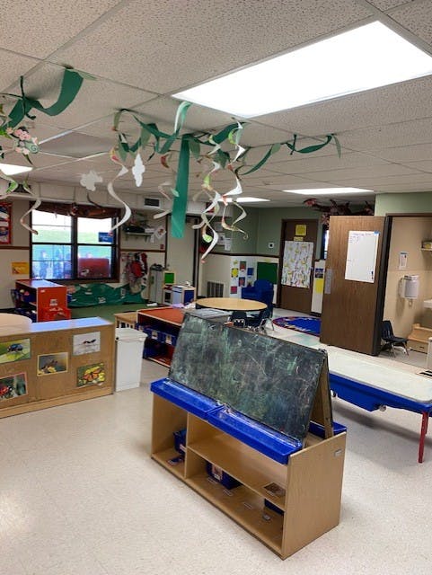 Classroom decorated with ceiling streamers and various learning stations