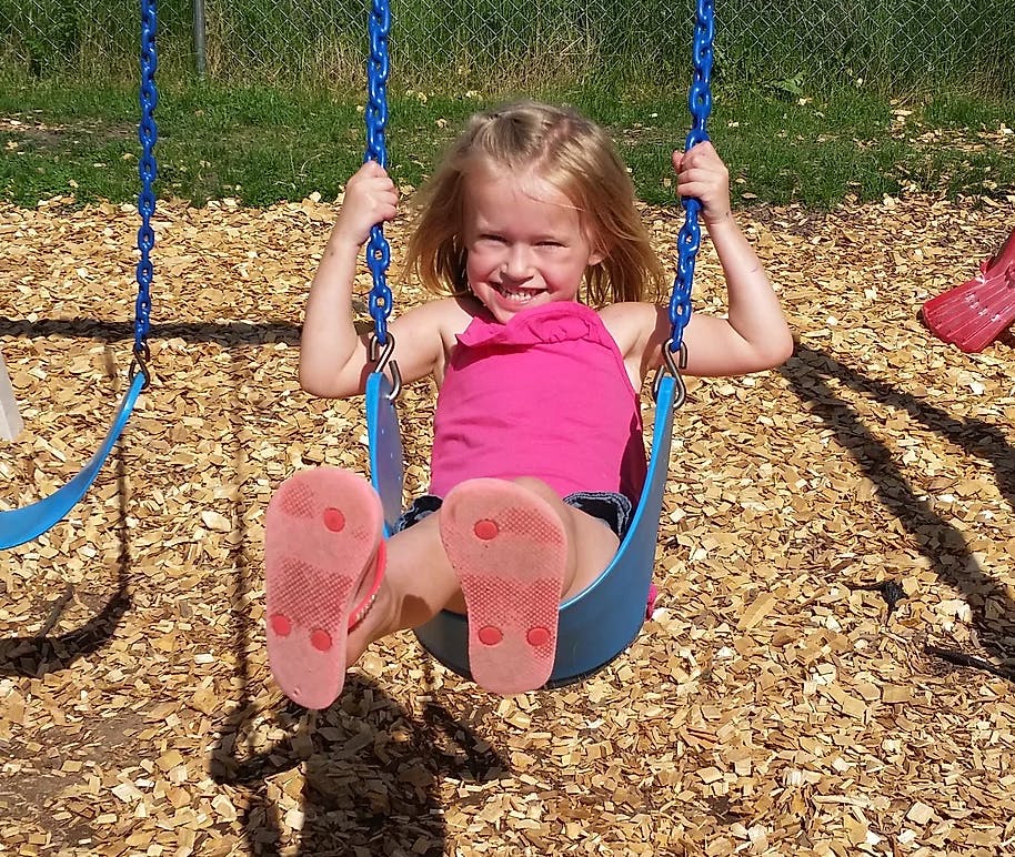 Child on a swing at a playground
