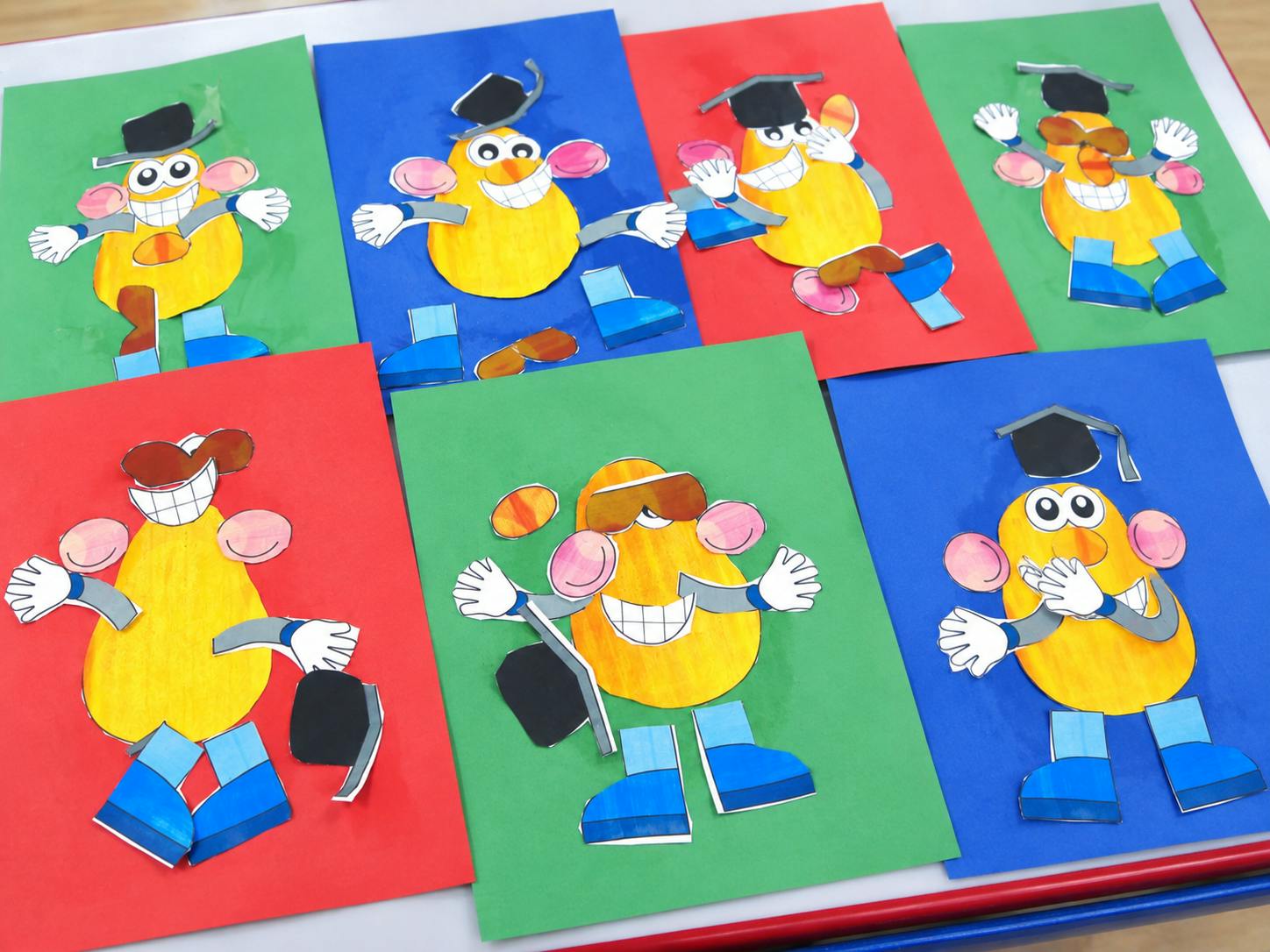 Several paper craft potato characters on colored backgrounds