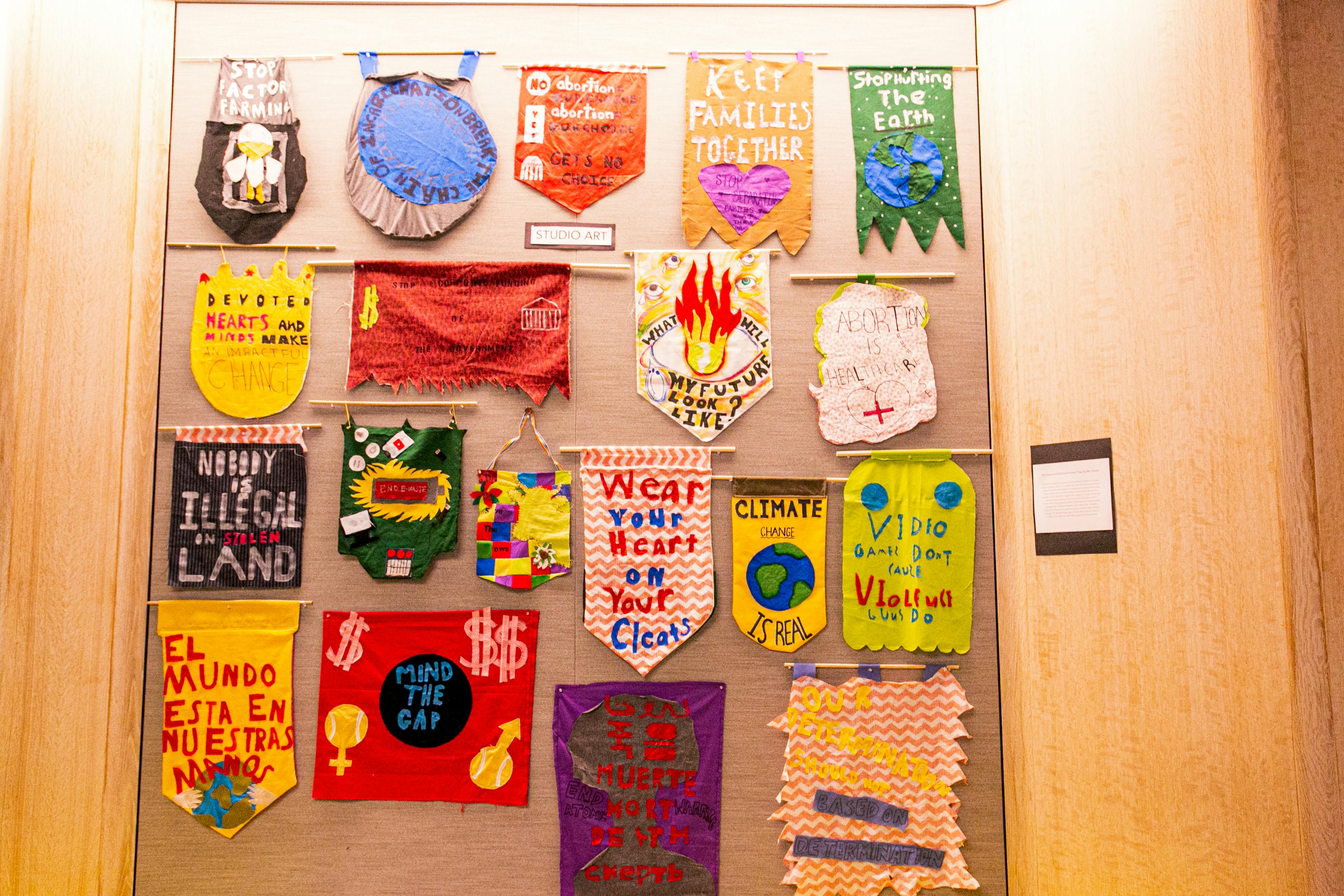 Display of various handmade banners with text and symbols