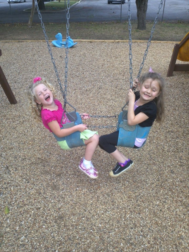 Two children on swings at a playground