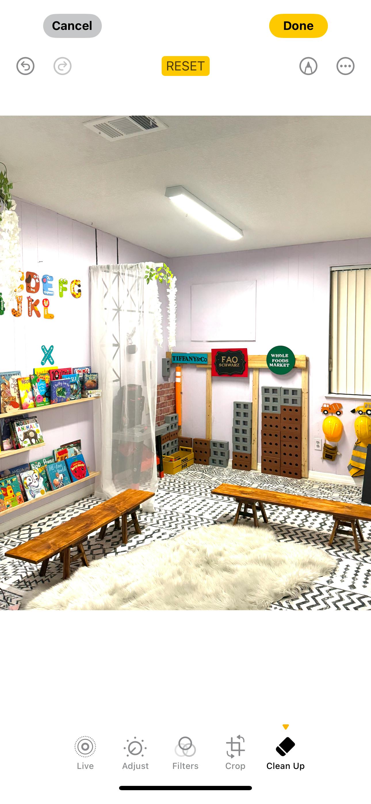 Children's play area with bookshelves, benches, and a rug