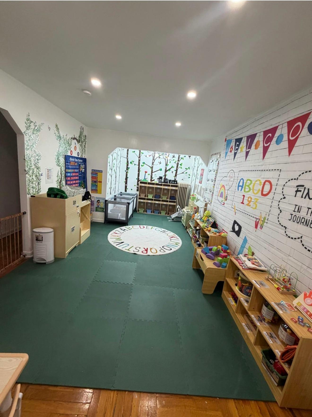 Childcare room with alphabet rug and educational wall decorations
