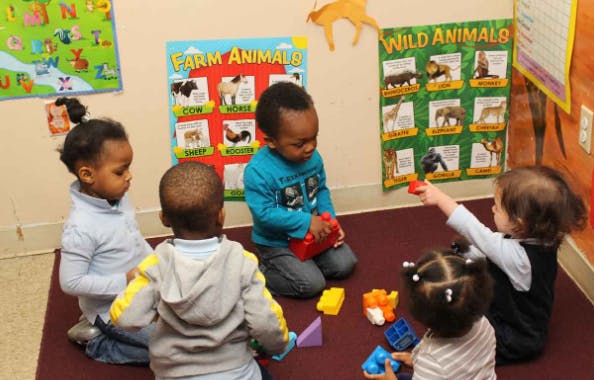 Children playing with toys in a classroom