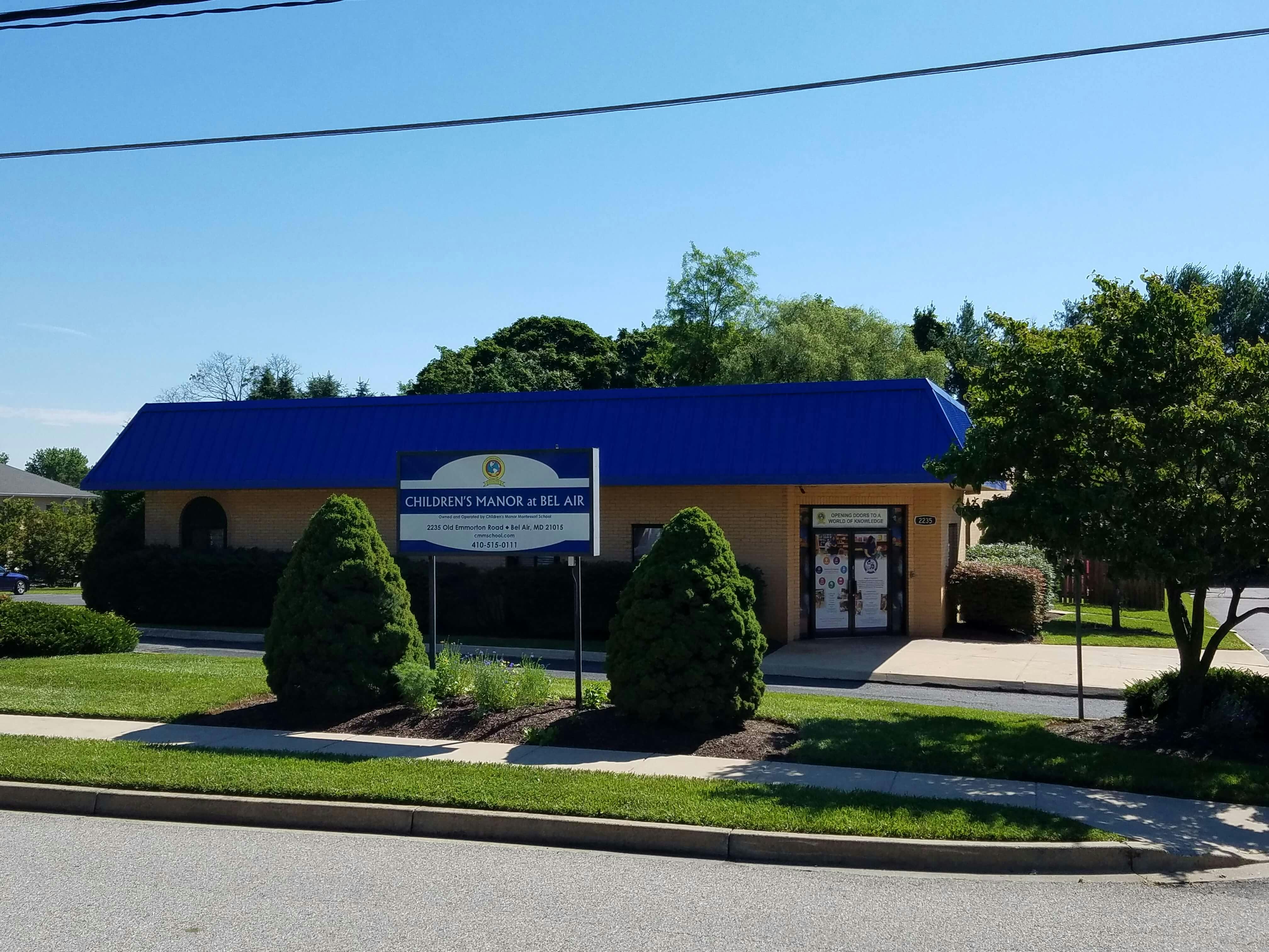 Building with a blue roof and a sign that reads "Children's Vision & Eye Care"