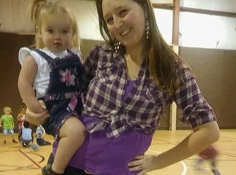 Person holding a child in a gym