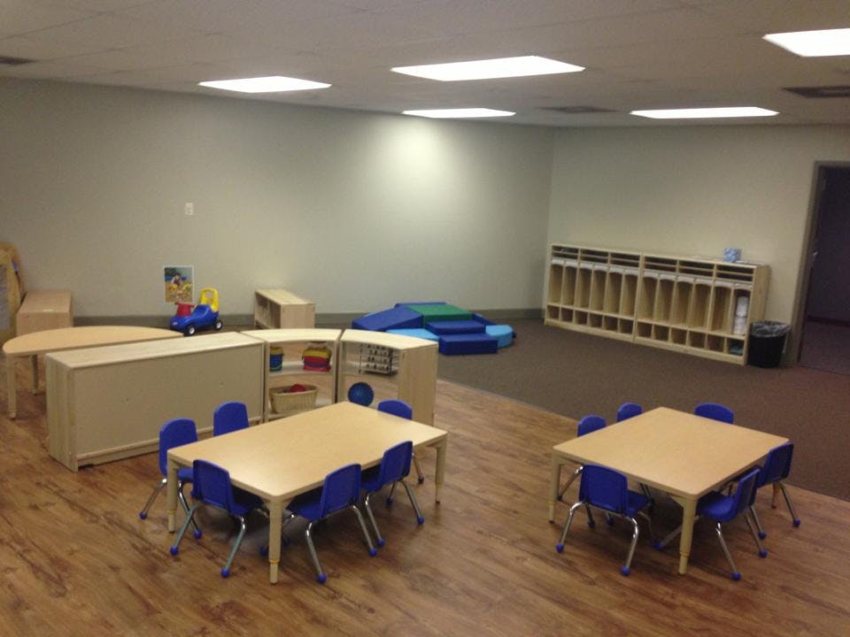 Empty classroom with small tables and chairs