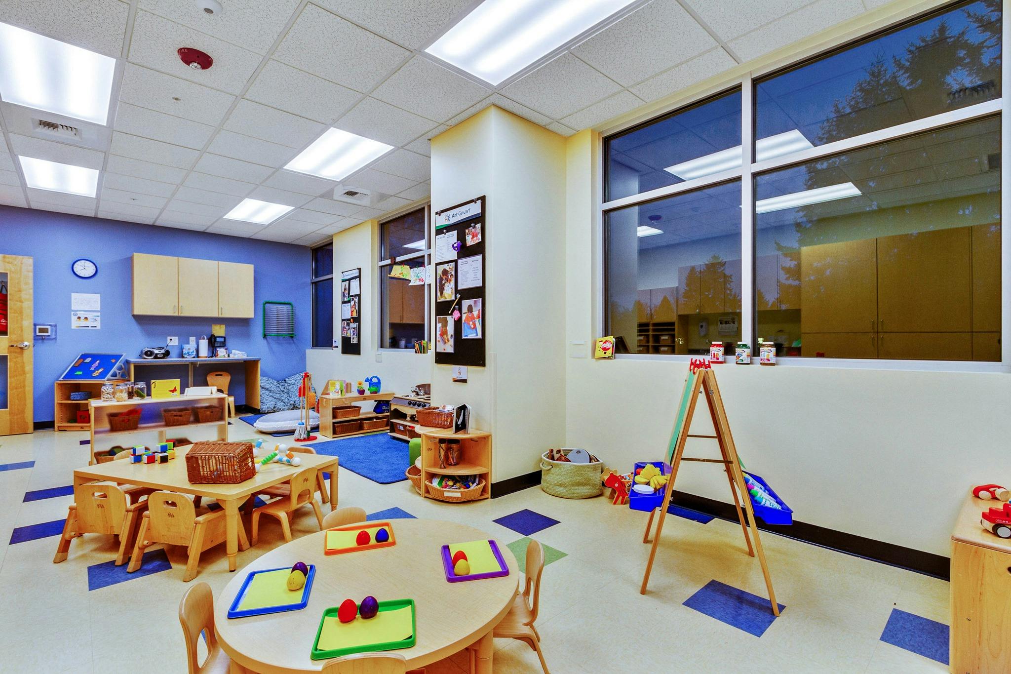 Empty classroom with small tables and chairs